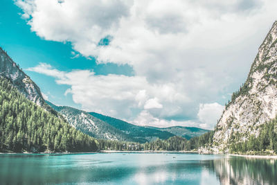 Scenic view of lake by mountains against sky