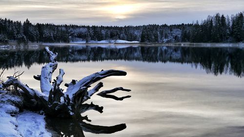 Frozen lake against sky during winter