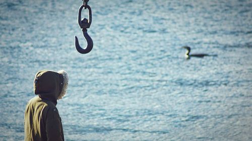 Rear view of boy looking at sea