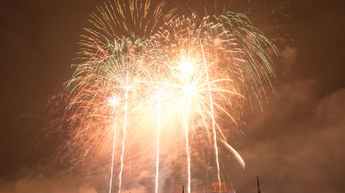 Low angle view of firework display at night