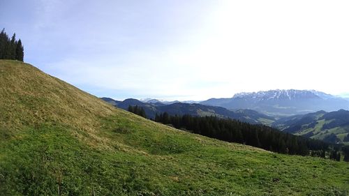 Countryside landscape against rocky mountains