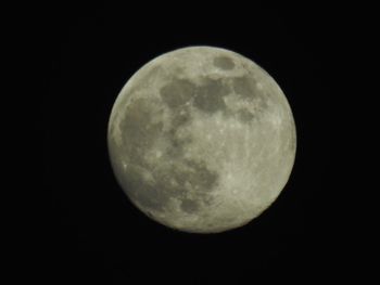 Low angle view of moon against clear sky at night
