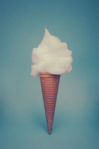 Ice cream cone against blue background