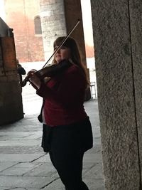 Woman with umbrella walking in city