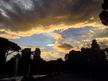 Silhouette trees against dramatic sky