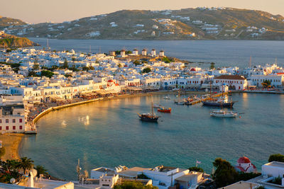 High angle view of townscape by sea against sky