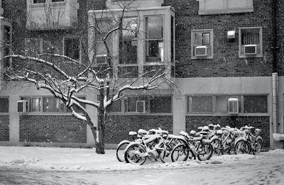 Bicycles on street against buildings in city during winter
