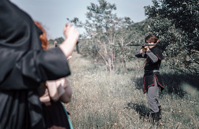 Man and woman standing on field