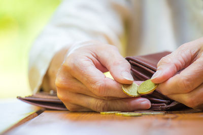 Midsection of woman counting coins