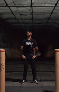 Portrait of man standing in illuminated building