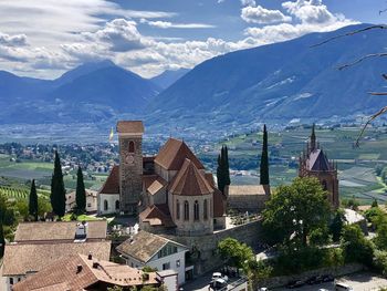 Panoramic view of buildings and mountains against sky