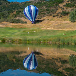 Hot air balloon flying over water