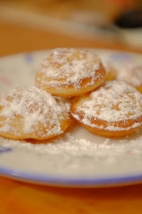 Close-up of dutch poffertjes on a plate on table