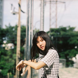 Portrait of smiling young woman standing outdoors