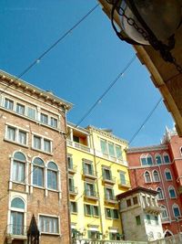 Low angle view of buildings against blue sky