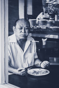 Portrait of a man sitting on table