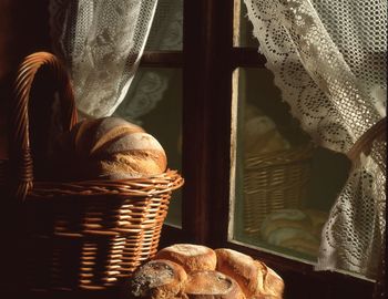 Brown breads in basket by closed window