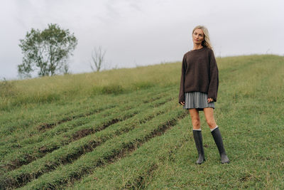 Rear view of woman standing on field