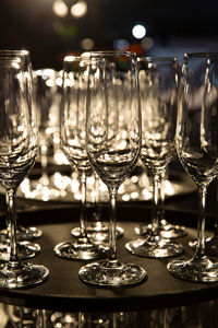 Empty champagne cups on tray with light shining through. vertical.