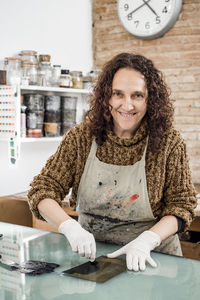 Woman artist preparing ink for an art print. using an ink stick