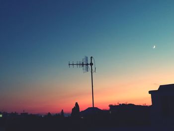 Silhouette buildings against sky during sunset