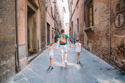 People walking on street amidst buildings