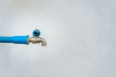 Close-up of water pipe against blue sky