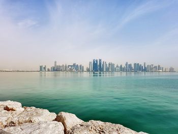 Scenic view of sea and buildings against sky