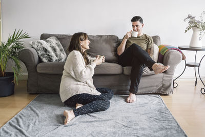 Woman sitting on sofa at home