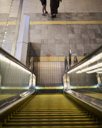 High angle view of people walking on escalator
