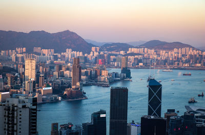 High angle view of city by sea against sky