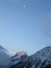 Low angle view of snowcapped mountains against sky during sunset