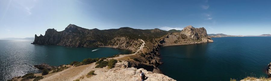 Panoramic view of sea and mountains against sky