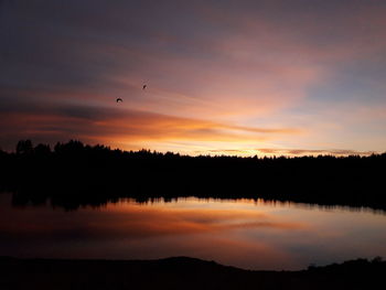 Scenic view of lake against sky during sunset