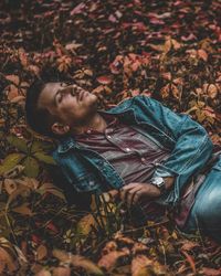 Man lying down on field during autumn