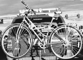 Bicycle parked on road against sky