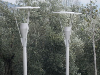 Close-up of street light against trees