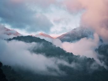 Scenic view of mountains against cloudy sky