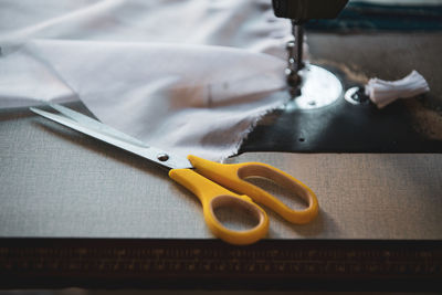 High angle view of scissors on sewing machine