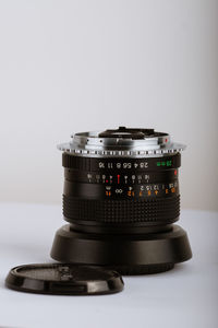 Close-up of camera on table against white background