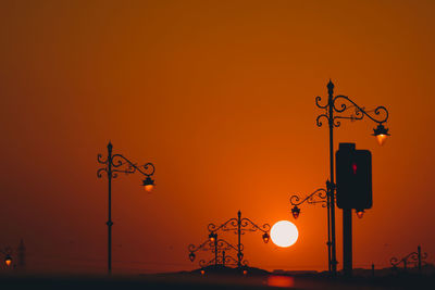 Low angle view of street light against sky during sunset