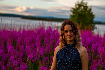 Portrait of beautiful woman standing in garden