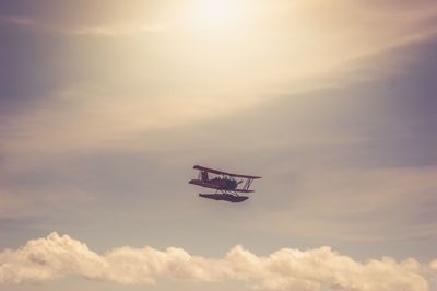 Low angle view of airplane flying in sky