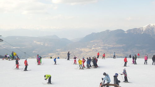 People enjoying in mountains against sky