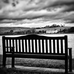 Pier on sea against cloudy sky