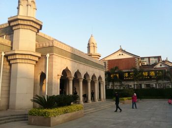 People in temple against clear sky