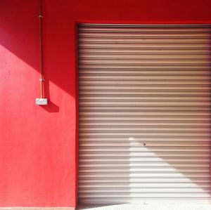 Closed shutter of red door