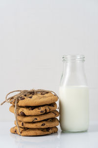 Close-up of cookies in plate against white background