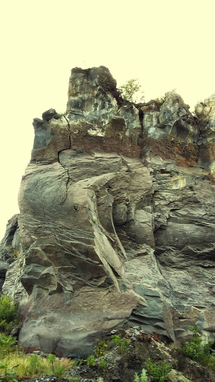 rock formation, rock - object, clear sky, rock, tranquility, cliff, tranquil scene, nature, geology, eroded, scenics, low angle view, sky, old ruin, beauty in nature, rocky mountains, rough, stone, non-urban scene, day