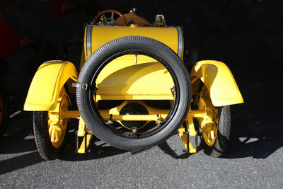 Close-up of yellow bicycle parked on road